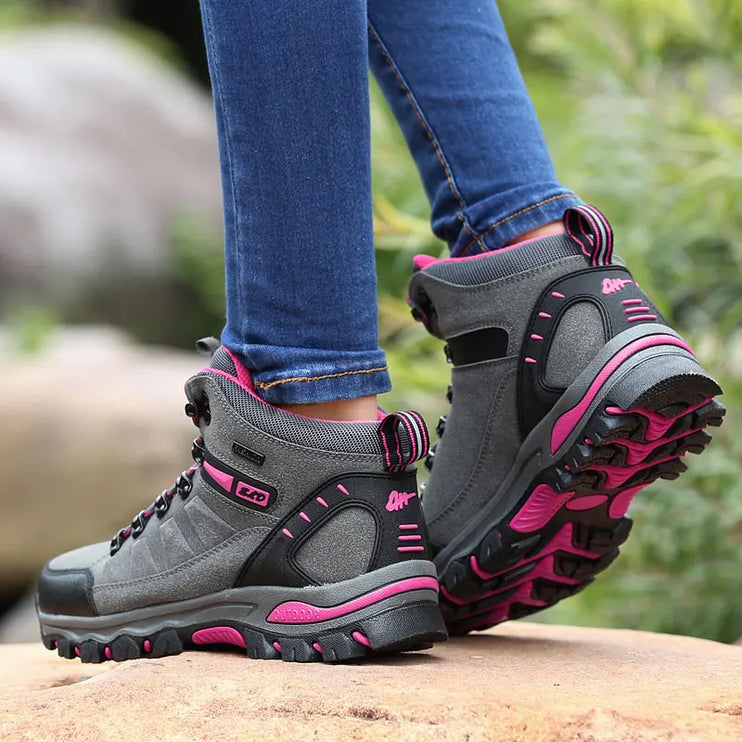 Women's waterproof snow boots, FrostGuard, with non-slip pink rubber soles and gray faux leather uppers, ideal for winter hiking.