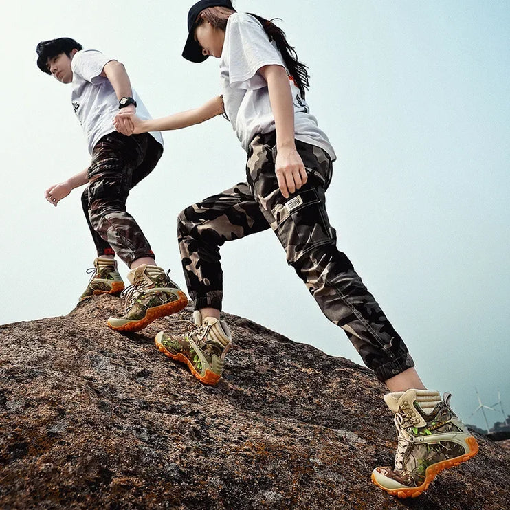 Hikers wearing TerraGuard Tactical Boots climb rocks, showcasing waterproof and slip-resistant features for outdoor adventures.